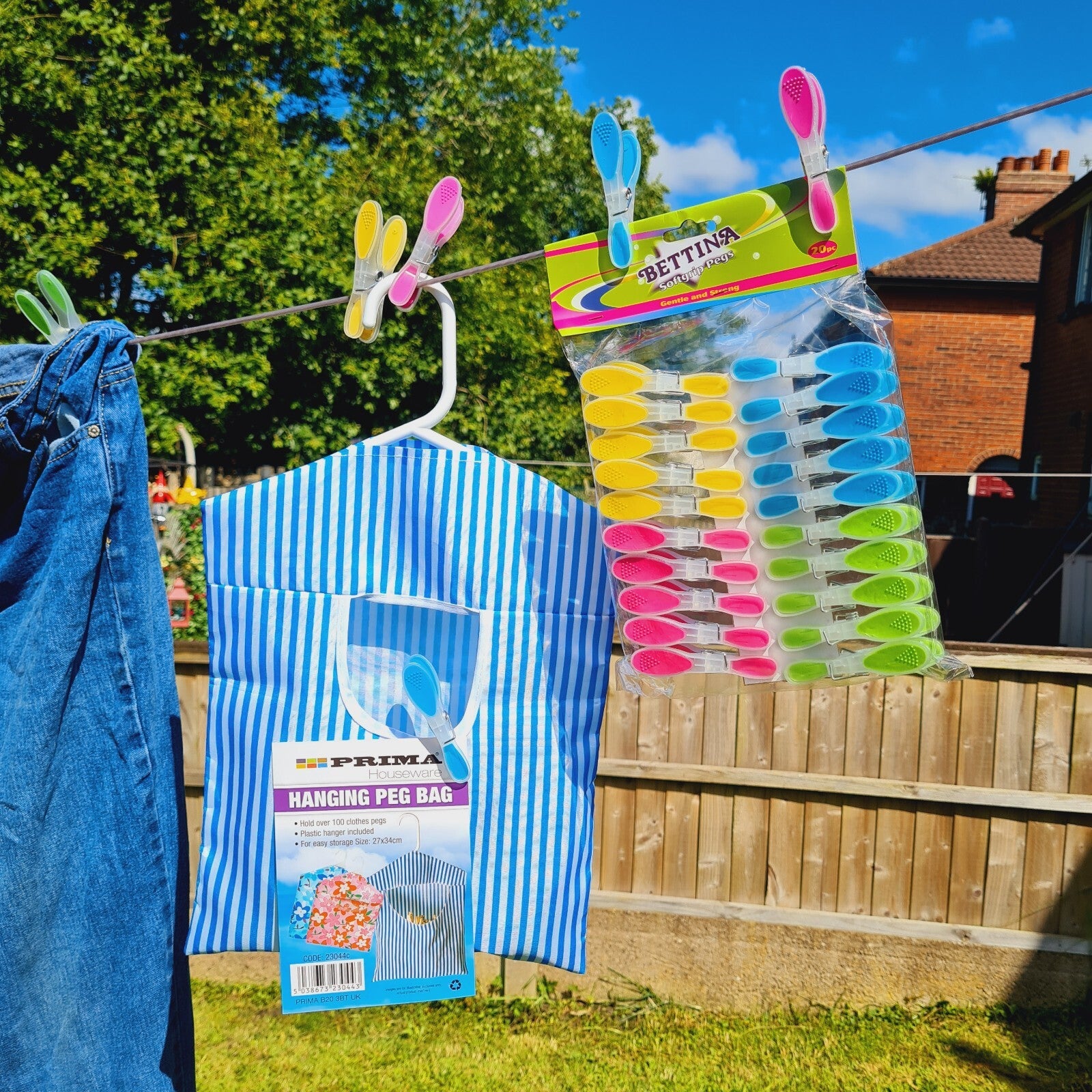 Hanging pegs and a peg bag on a clothesline with a clear sky background