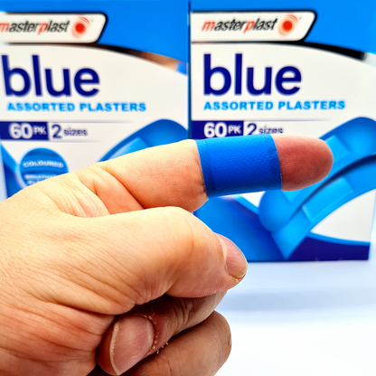 Hand wearing a blue plaster with Masterplast packaging in the background