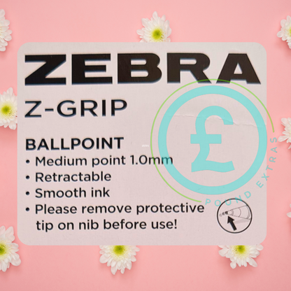 Zebra Z-Grip ballpoint pen packaging with product details on a pink background with flowers.